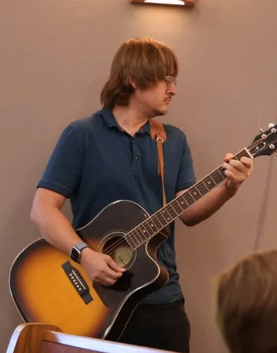 Beau Christ playing guitar at church